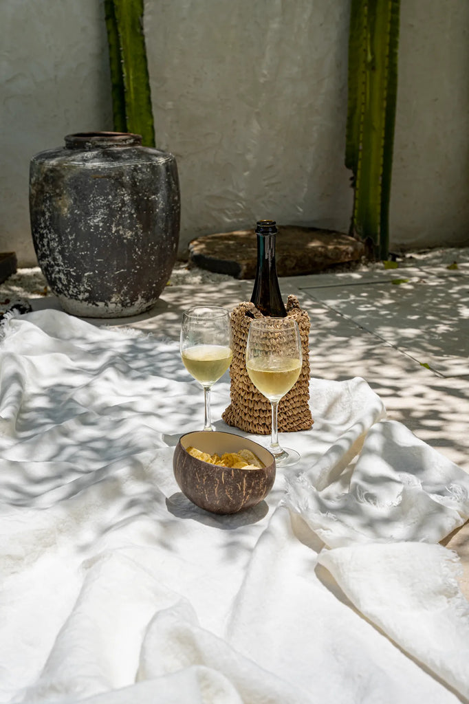 festive setting of coconut bowl and wine bottle with glasses